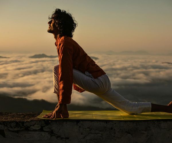 Serene person practicing yoga during a sunrise.